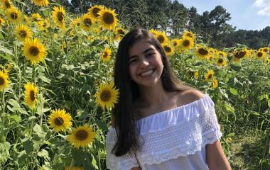 headshot of sophia in a sunflower field